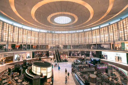 Dubai, UAE - 12.01.2019: People walking by and shopping inside of the Dubai Mall. Several shopping floors, busy as usual.のeditorial素材