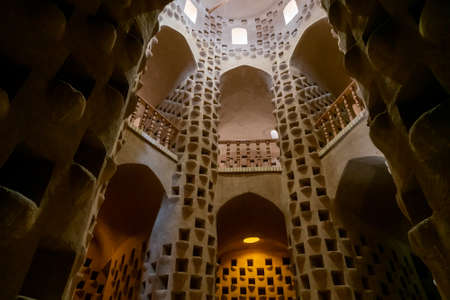 Meybod, Iran - 12.04.2019: Interior of Pigeon Tower in Meybod, Yazd Province, Iran. Old pigeon house in ancient Persia with lots of pigeon holes. Ancient mud brick architecture. Persia.の写真素材