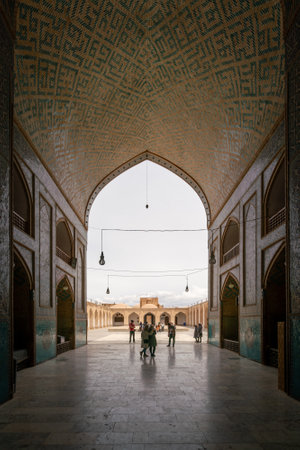 Yazd, Iran - 13.04.2019: Courtyard of historical Jameh Mosque of Yazd with its hexagonal and turquoise tiles. People walking in the yard of Shia mosque. Persia.のeditorial素材