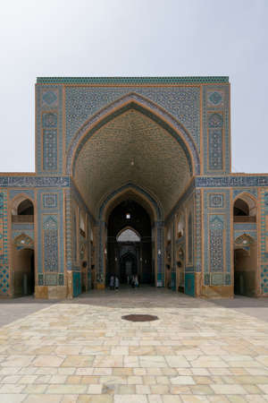 Yazd, Iran - 13.04.2019: Courtyard of historical Jameh Mosque of Yazd with its hexagonal and turquoise tiles. People walking in the yard of Shia mosque. Persia.のeditorial素材