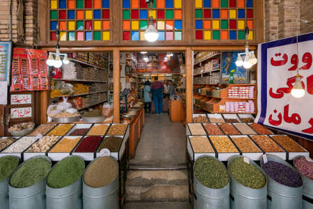 Kerman, Iran - 04.19.2019: Colorful grains and spices in front of a spice shop in persian bazaar.