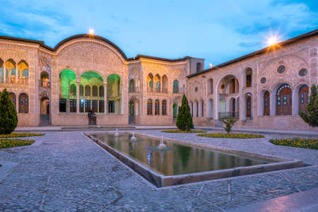 Kashan, Iran - 19.04.2019: Courtyard of the richly decorated Tabatabaei historical house. Facade...