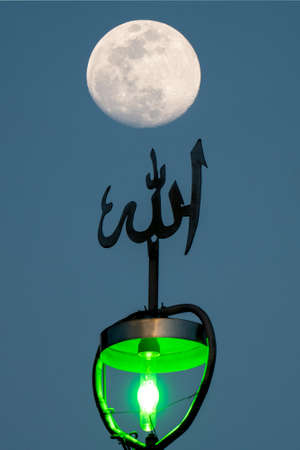 A full moon shining above islamic ornament. Mystical evening in ancient Persia. God, soul and universe.の写真素材