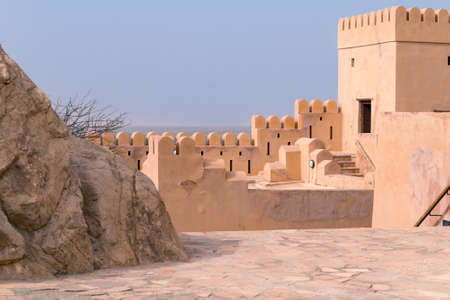 Nakhal,Oman - 04.01.2018: Yard inside the medieval arabian fort of Nakhal, Oman. Fortification walls, rock, stone floor, blue sky. Medieval middle east castle.のeditorial素材