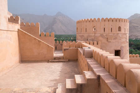 Nakhal,Oman - 04.01.2018: Yard inside the medieval arabian fort of Nakhal, Oman. Fortification walls, rock, stone floor, blue sky. Medieval middle east castle.のeditorial素材