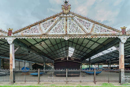 Antwerp, Belgium - 04.29.2018: Old metal boat shelter with decorated facade in the harbor. A ship under the roof. Cloudy day.のeditorial素材