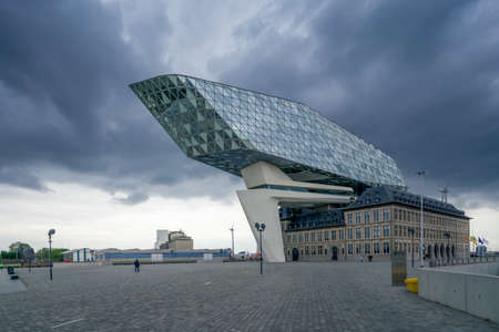 Antwerp, Belgium - 04.29.2018: Modern building of Port Authority Building on a cloudy, rainy day. Famous architecture of Belgium.のeditorial素材