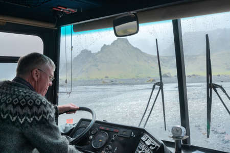 Thorsmork,Iceland-06.05.2019: Driver of an off-road bus pays close attention when crossing river in Thorsmork valley, Southern Iceland.のeditorial素材