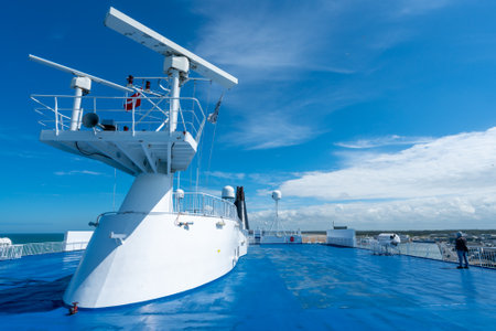 Hirsthals, Denmark - 08.06.2017: Top deck of a Smyril line cruising ship heading from Denmark to Iceland. White radars against the blue sky on a sunny day. Cruising the ocean.のeditorial素材