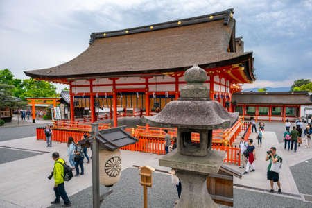 Kyoto, Japan - 15.05.2019: People and tourists walking in the complex of world famous Fushimi Inari...
