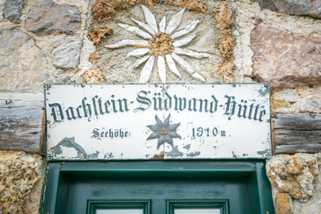 Dachstein, Austria - 09.23.2018: Sign above the green door of Sudwand Hutte in the Hoher Dachstein area in Austrian Alps.のeditorial素材