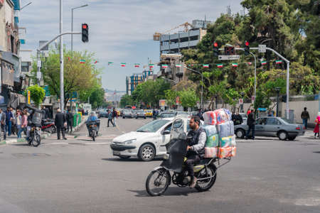 Tehran, Iran - 18.04.2019: Busy traffic in the streets of Iranian capital. Cars and bikes in the streets of Tehran.の写真素材