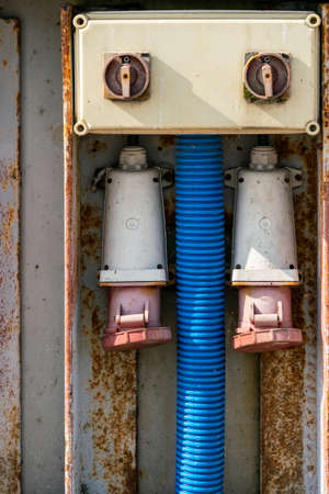 Detail vertical shot of massive old outdoor electric sockets on concrete harbor pier in port of Hel, Poland. Electricity for naval vessels. Rough harbor tech.の写真素材