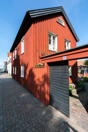 Vastervik, Sweden - 08.23.2021: Wide vertical shot of old, traditional red wooden house in scandinavian style. Sunny summer day.のeditorial素材