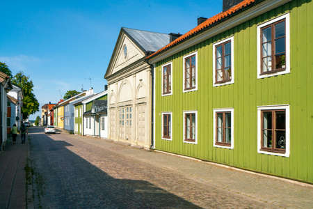 Vastervik, Sweden - 08.23.2021: Street near the center with old, traditional colorful wooden houses in scandinavian style. Sunny summer day.のeditorial素材