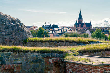 Cityscape of Vastervik, Sweden, with St.Peters Church tower on the horizon and flowers in the front. Sunny summer day in southern Sweden.のeditorial素材