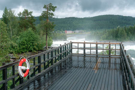 Stordorsen, Sweden - 08.15.2021: Storforsen, wild, huge waterfall on Pite River in Swedish arctic on a cloudy, rainy day of arctic summer. Norrbottens area. Wild nature of Swedish Lapland.のeditorial素材