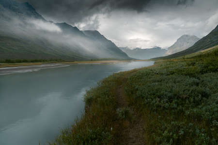 Heavy clouds rolling above remote arctic valley. Rapadalen, Sarek National Park, Swedish Lapland.の写真素材