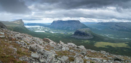 Vast arctic landscape of Sarek National Park in Swedish Lapland with Rapa valley, Tjahkelij, Skierffe, Nammasj peaks and Lajtavrre lake in the backの写真素材