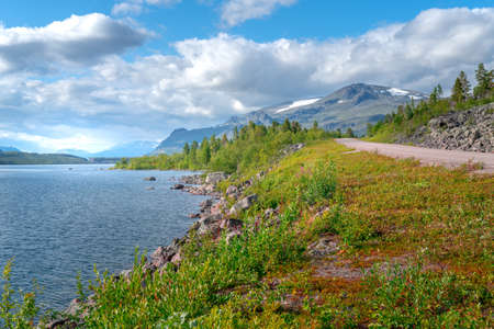 Lulealven lake, Sweden, with mountains of Stora Sjofallet National Park in the back on a day of arctic summer. Wild nature of the far north.の写真素材