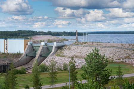 Porjus, Sweden - 08.15.2021: Detail of steel gate of Lulealven dam in Porjus, Sweden, with Porjus Hydroelectric Power Station to the left.の写真素材