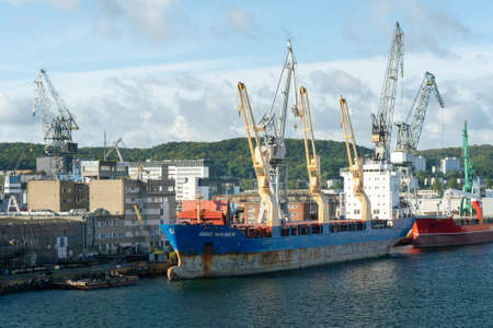 Gdynia, Poland - 09.23.2021: BBC Wesser vessel being loaded by yellow cranes.のeditorial素材