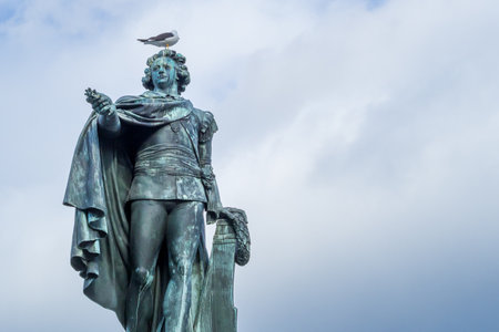 Stockholm, Sweden - 04.15.2017: Detail shot of Gustav the Third monument in Stockholm with yelow legged gull sitting on the top.のeditorial素材