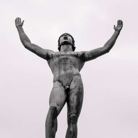 Stockholm, Sweden - 04.15.2017: Detail wide low angle shot of Solsangaren, The Sun Singer, statue against bright sky. Statue in front of the Swedish Parliament.のeditorial素材