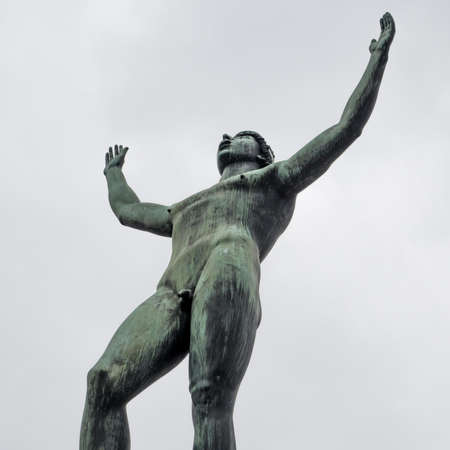 Stockholm, Sweden - 04.15.2017: Detail wide low angle shot of Solsangaren, The Sun Singer, statue against bright sky. Statue in front of the Swedish Parliament.のeditorial素材