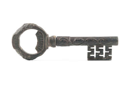 Wide high angle studio shot of very old metal vintage decorative key with word Veritas on it, isolated on white background. Concept for security, opportunity.の写真素材