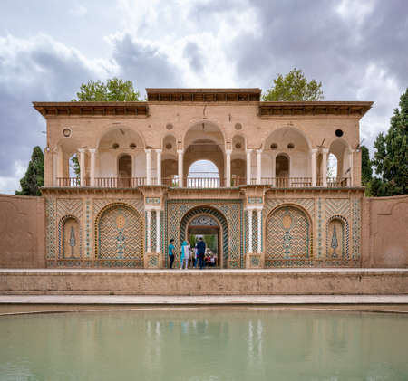 Mahan, Iran - 04.09.2019: Water pool in front of the gate of Shahzadeh Mahan Historical Garden,...