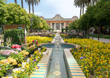 Shiraz, Iran - 04.14.2019: People walking in Eram persian garden of Shiraz on a beautiful sunny day. Lots of colorful flowers in beautiful persian garden.のeditorial素材