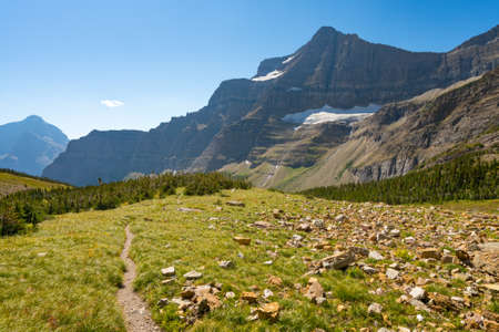 Matahpi Peak and valley below viewed from Siyeh Pass hiking trail, Glacier National Park, Montana. Sunny summer day high in American Rockies. Mountain range and valley bellow on a sunny day.の写真素材