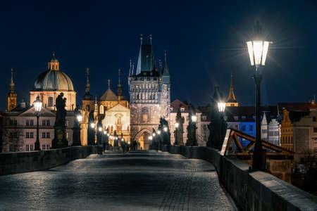 Prague, Czechia - 02.17.2022: View of Old Town Bridge Tower from Charles Bridge in the dark night. Prague center without people. Beautiful historical buildings in central european capital.のeditorial素材