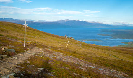 Wooden markers on Nuolja, or Njulla mountain, in Abisko National Park in arctic Sweden. Adventure in arctic wilderness. Hiking in Swedish Lapland. Beautiful day of arctic summer. Tornetrask lake.の写真素材