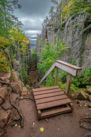 Slattdalsskrevan Canyon in Skuleskogen National Park, Sweden. Narrow crevasse in solid rock on a cloudy summer day. Hiking along the High Coast Trail in Sweden. Hohe Kustenleden trail.の写真素材