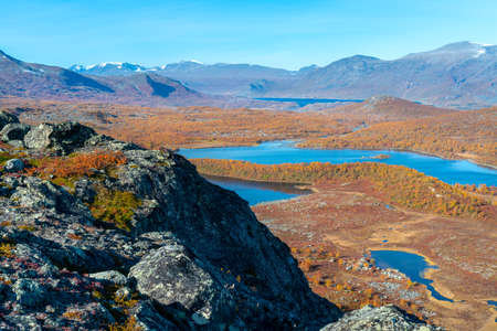 Epic view of vast arctic landscape of Stora Sjofallet National Park, Sweden, on autumn day....