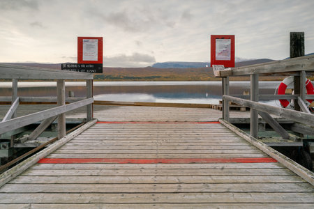 Kebnats, Sweden - 09.19.2021: Wooden pier and mountains above the lake with wooden pier in...