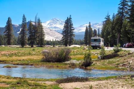 Camper caravan parked amidst Sierra Nevada mountain range in Yosemite National Park, California, USA. Vast landscape with forests and mountain peaks on a beautiful sunny day.Sのeditorial素材