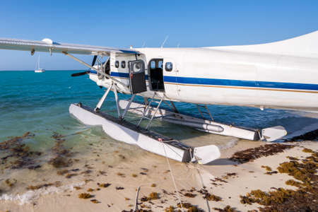 Cool old hydroplane with open door sitting on a sandy beach. Beautiful summer day in Dry Tortugas,...