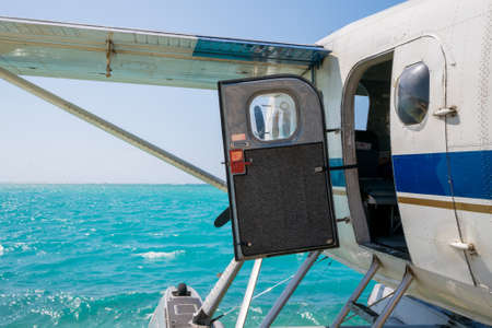 Cool old hydroplane with open door sitting on a sandy beach. Beautiful summer day in Dry Tortugas,...
