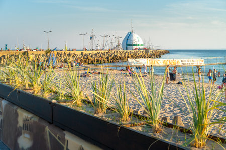 Hel, Poland - 08.01.2021: So called Egg building and ocean pier behind it in port of Hel in late afternoon on a sunny day with soft clouds in the background.のeditorial素材