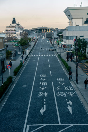 Yokohama, Japan - 12.09.2022: Vertical shot of Yokohama port dock with road leading to it in front and big ocean liner dockedのeditorial素材