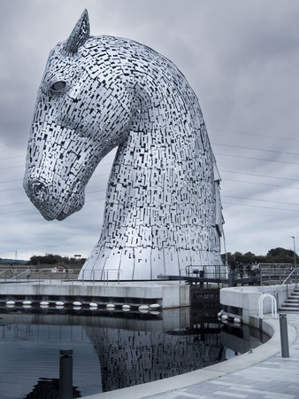 Grangemouth, Scotland - 08.25.2016: Giant metal Kelpies sculptures on a cold and cloudy day. Famous tourist attraction in Scotland. Giant horses statues.のeditorial素材