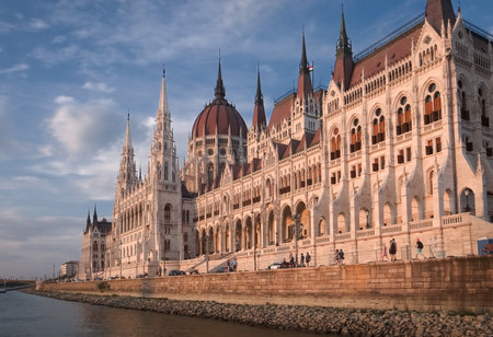 Budapest, Hungary - 15.05.2015: Wide horizontal shot of Budapest parliament, Orszaghaz, from Danube river in a beautiful golden hour light agains dark blue sky.のeditorial素材