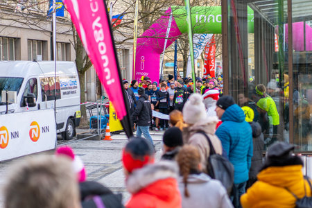 Ostrava, Czechia - 02.04.2023: Large group of people of all ages at the start of an amateur winter run race in the city. Competitors of Innogy winter run in Ostrava. Outdoor activities for all people.のeditorial素材