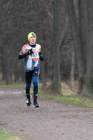 Ostrava, Czechia - 02.04.2023: Vertical shot of male runners in sportswear competing during winter amateur run race. Run competition during cold winter day. Innogy winter run.のeditorial素材