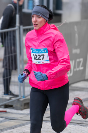 Ostrava, Czechia - 02.04.2023: Vertical shot of male runners in sportswear competing during winter amateur run race. Run competition during cold winter day. Innogy winter run.のeditorial素材