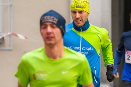 Ostrava, Czechia - 02.04.2023: Horizontal shot of male runners in sportswear competing during winter amateur run race. Run competition during cold winter day. Innogy winter run.のeditorial素材