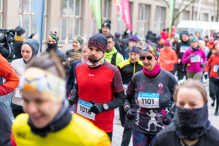 Ostrava, Czechia - 02.04.2023: Large group of people of all ages at the start of an amateur winter run race in the city. Competitors of Innogy winter run in Ostrava. Outdoor activities for all people.のeditorial素材